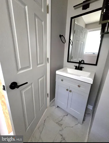 a bathroom with a sink mirror vanity and toilet