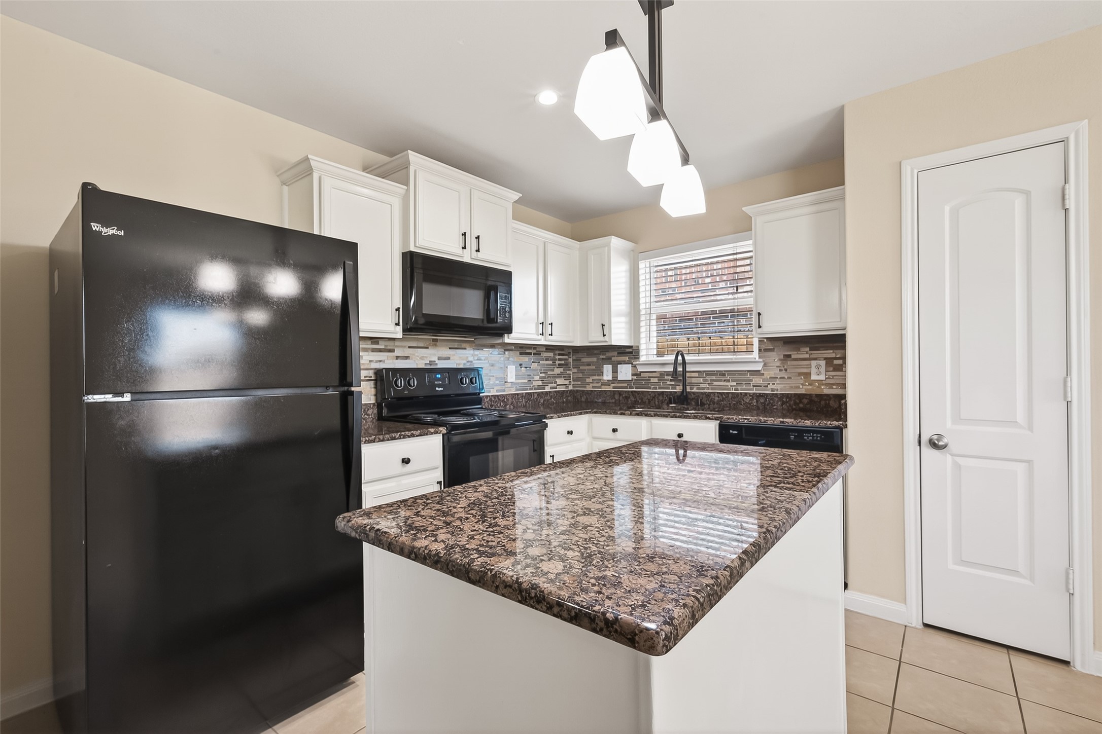2319 Seabourne Trails Road Rosenberg, TX 77469 - Photo 11 of 36 a kitchen with a refrigerator a microwave a sink and cabinets