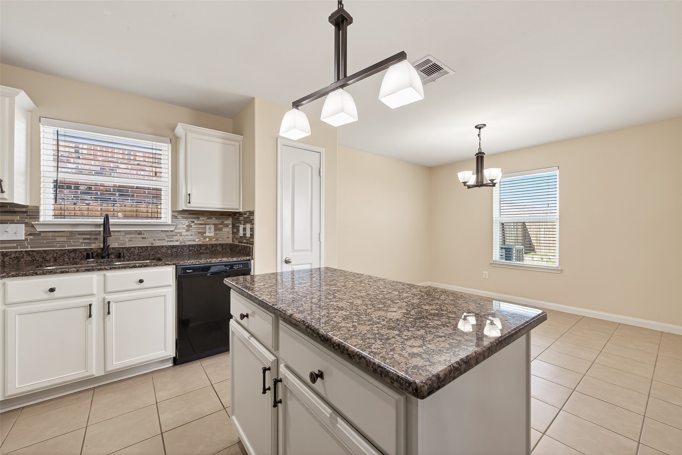 2319 Seabourne Trails Road Rosenberg, TX 77469 - Photo 12 of 36 a kitchen with granite countertop stove sink and refrigerator