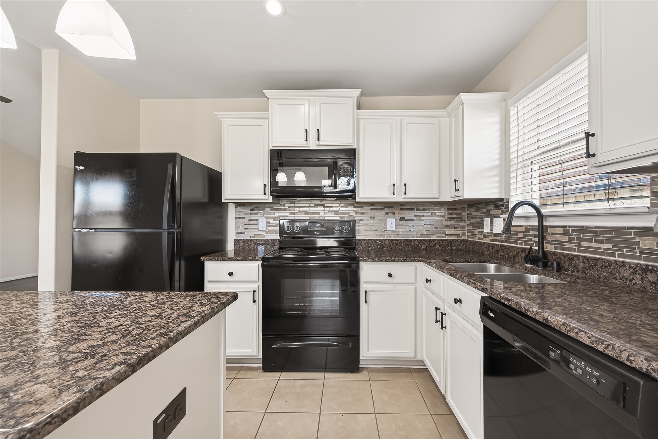 2319 Seabourne Trails Road Rosenberg, TX 77469 - Photo 16 of 36 a kitchen with a sink stove and refrigerator