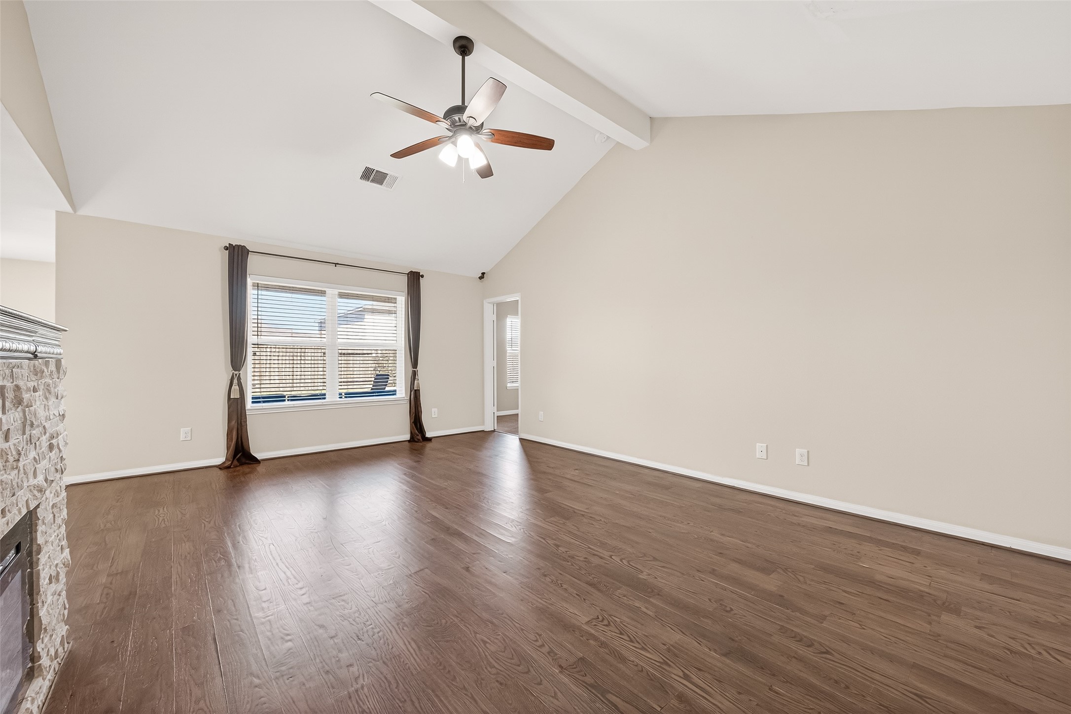 2319 Seabourne Trails Road Rosenberg, TX 77469 - Photo 8 of 36 a view of an empty room with wooden floor and a ceiling fan