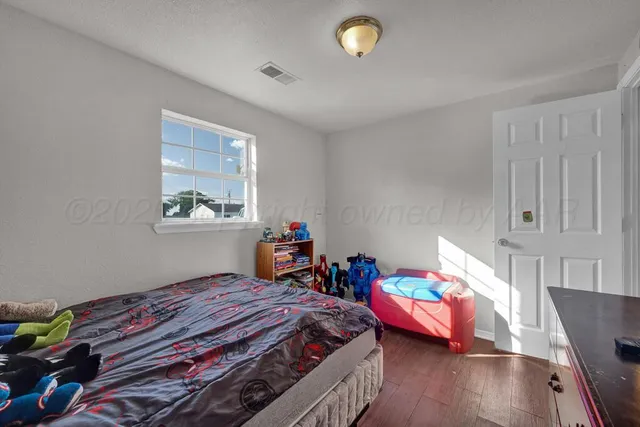 a bedroom with bed and a window
