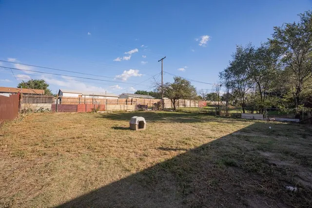 a view of a house with a yard covered in snow