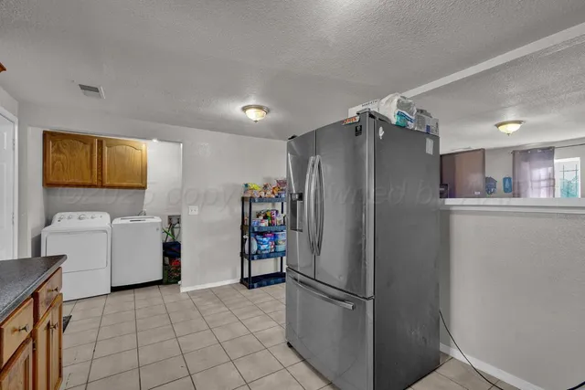 a kitchen with a refrigerator and a sink