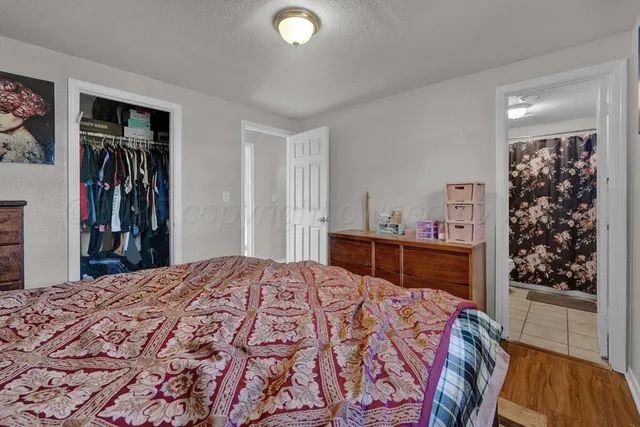 a bed sitting in a bedroom and a large mirror