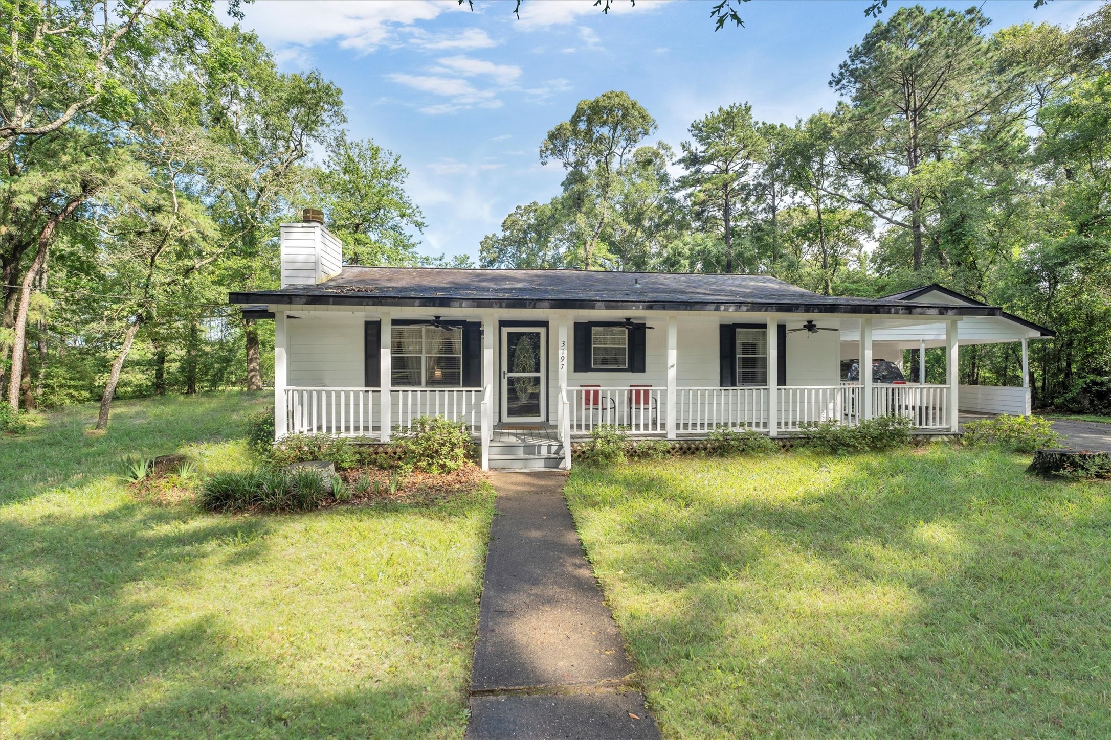 a front view of house with yard and green space