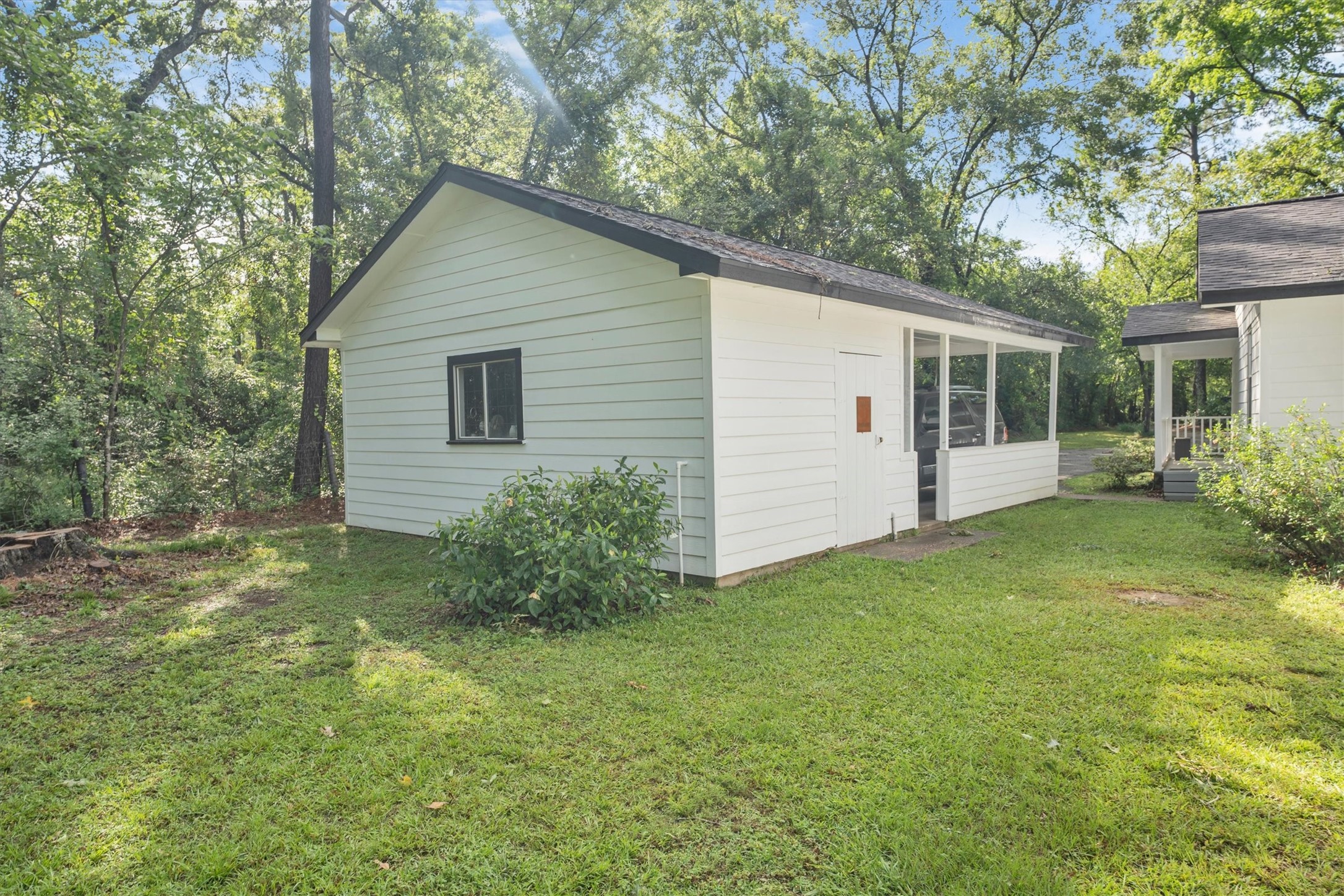 3197 Mann Road Conroe, TX 77303 - Photo 16 of 48 a view of backyard with potted plants and a large tree