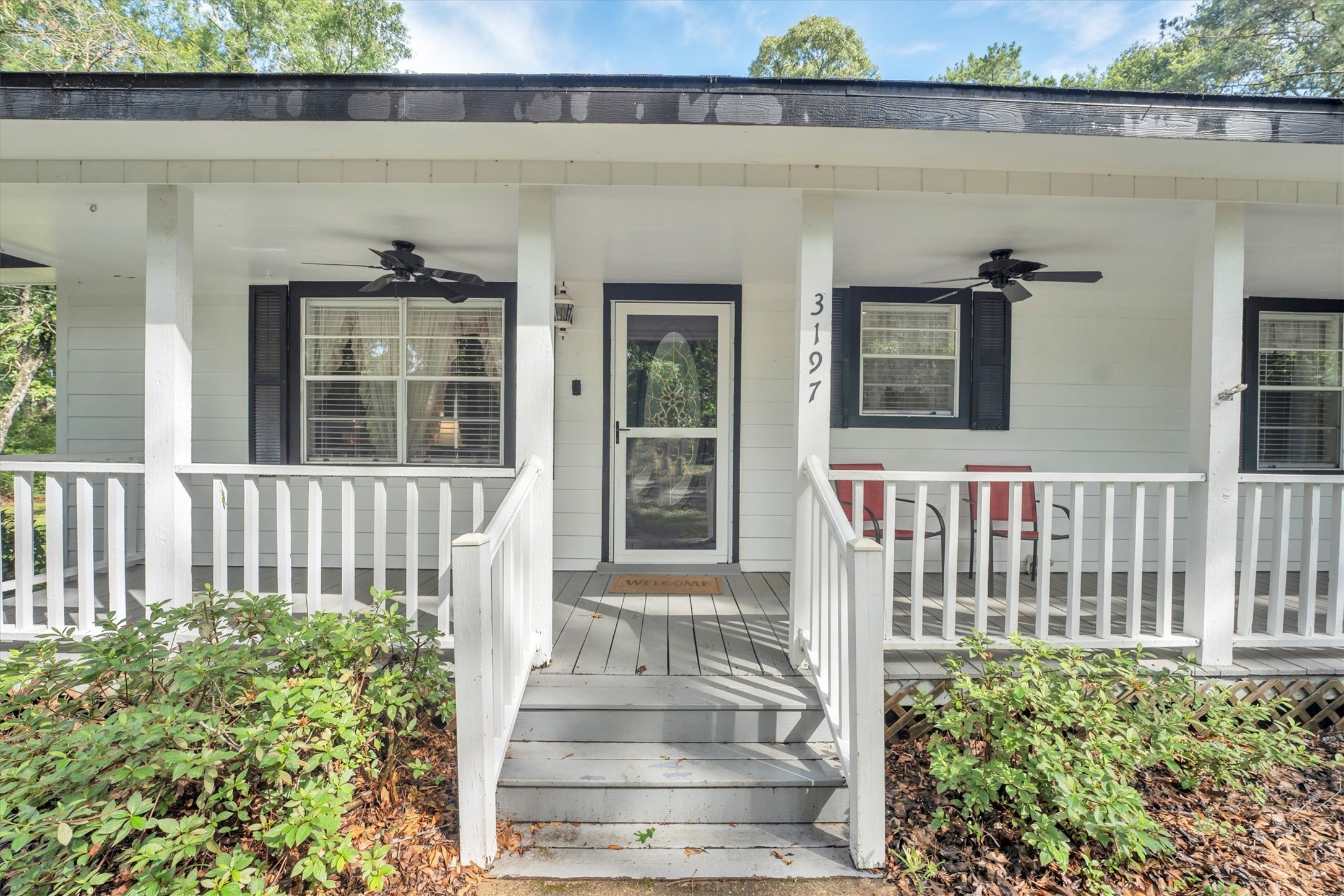 3197 Mann Road Conroe, TX 77303 - Photo 2 of 48 a front view of a house with a porch