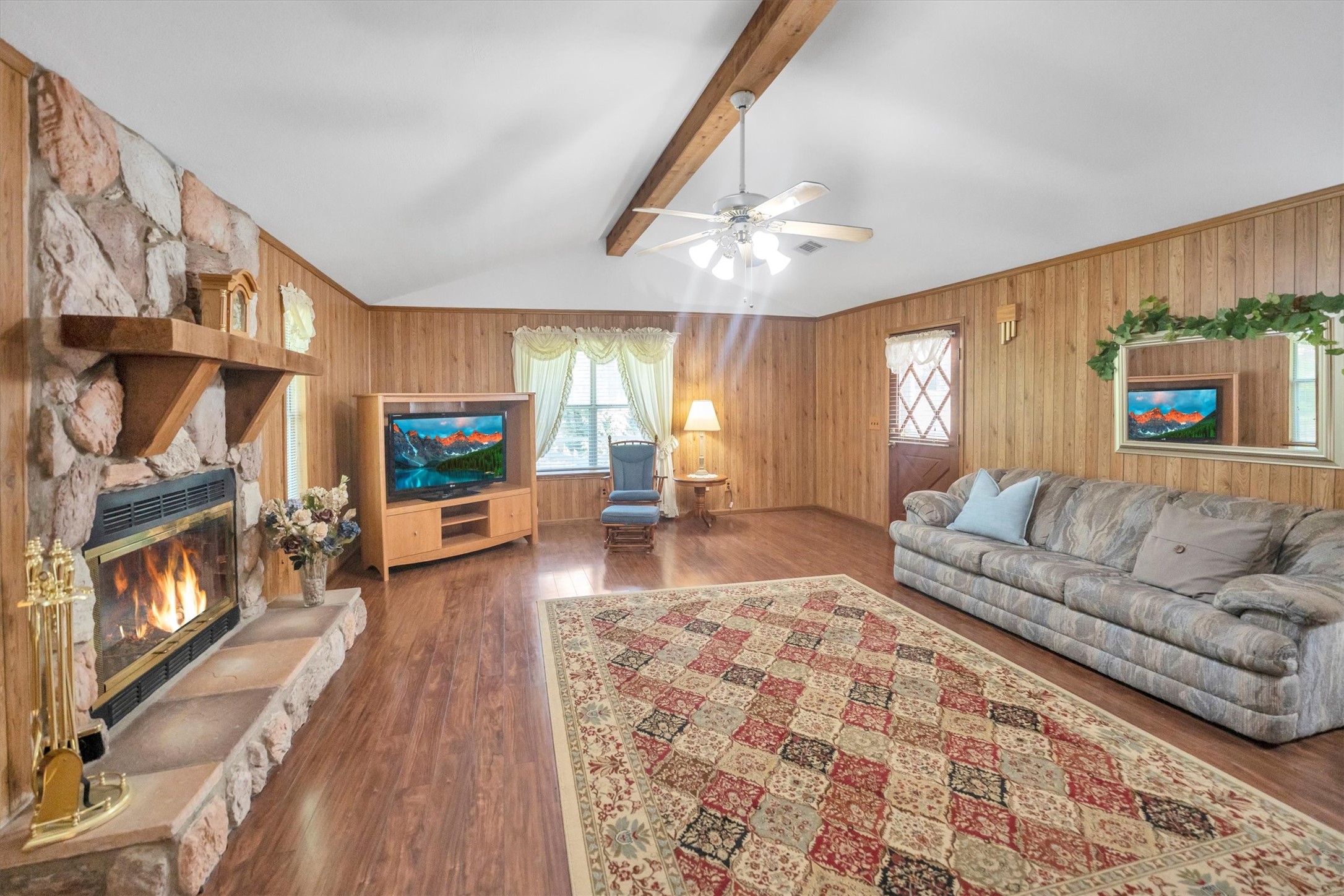 3197 Mann Road Conroe, TX 77303 - Photo 21 of 48 a living room with furniture and a fireplace