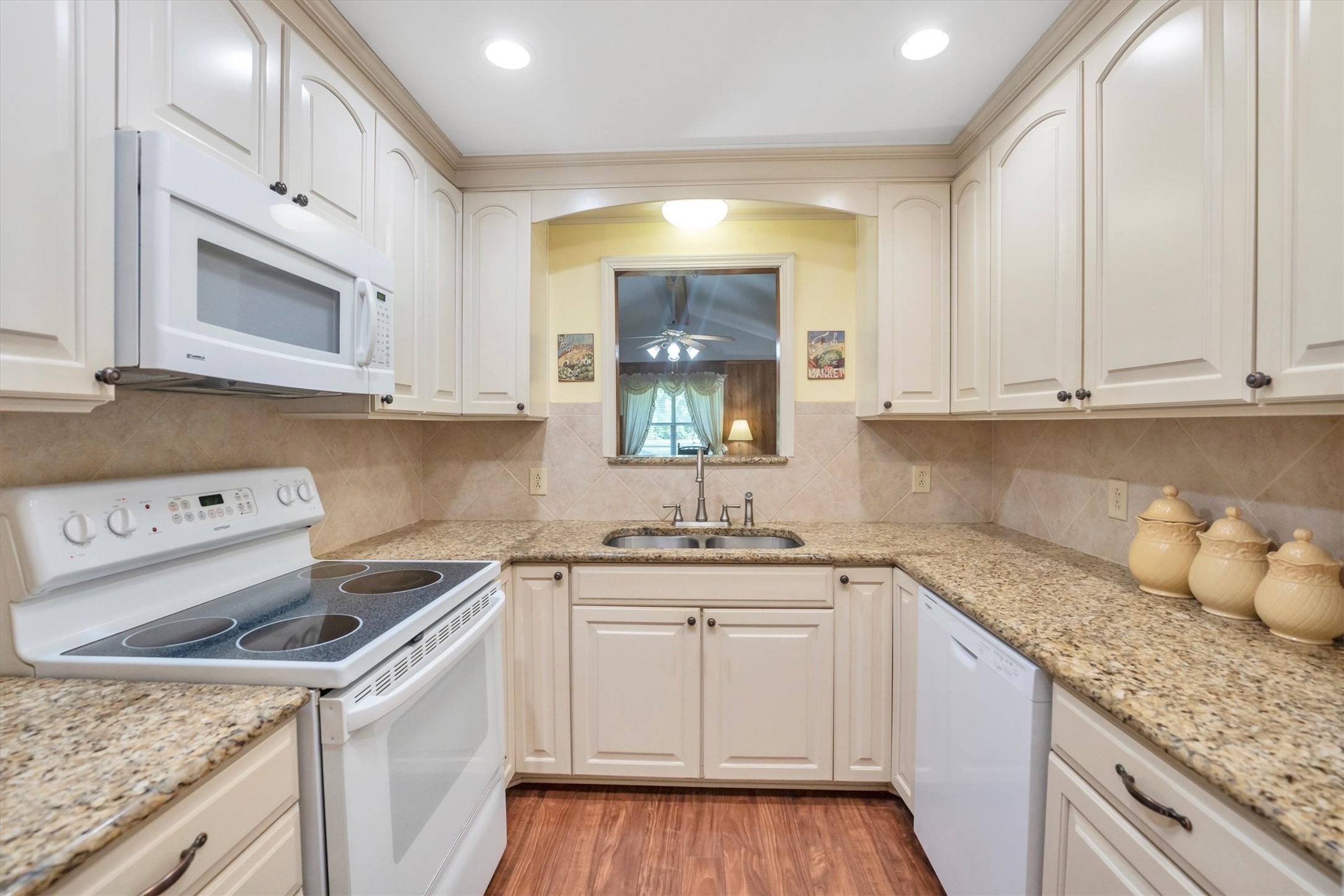 3197 Mann Road Conroe, TX 77303 - Photo 25 of 48 a kitchen with white cabinets appliances and a sink