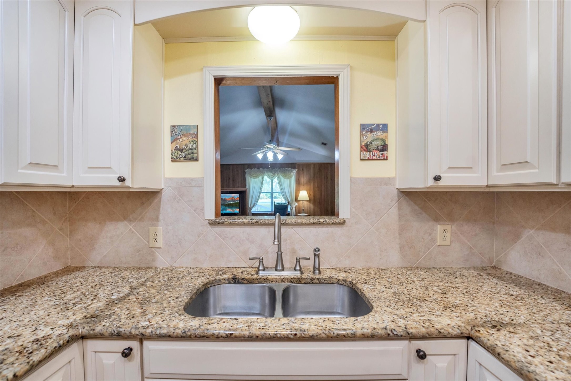 3197 Mann Road Conroe, TX 77303 - Photo 26 of 48 a kitchen with granite countertop a sink and cabinets