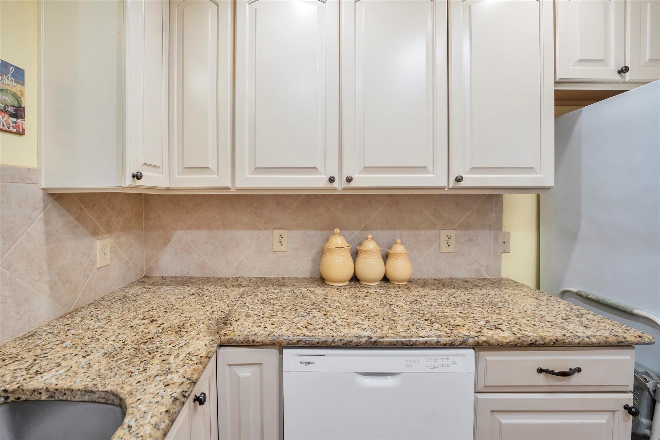 3197 Mann Road Conroe, TX 77303 - Photo 27 of 48 a kitchen with granite countertop white cabinets and a white countertops