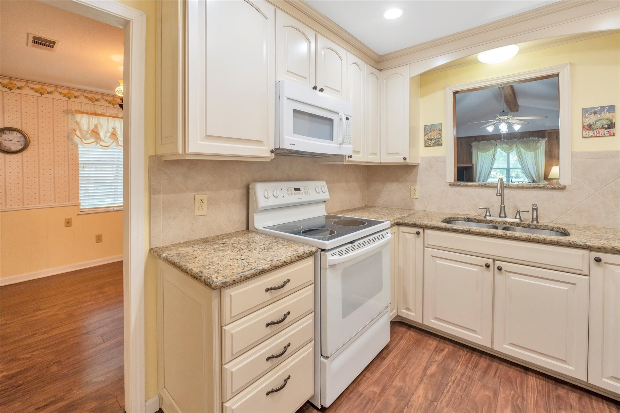 3197 Mann Road Conroe, TX 77303 - Photo 28 of 48 a kitchen with stainless steel appliances granite countertop a sink stove and cabinets