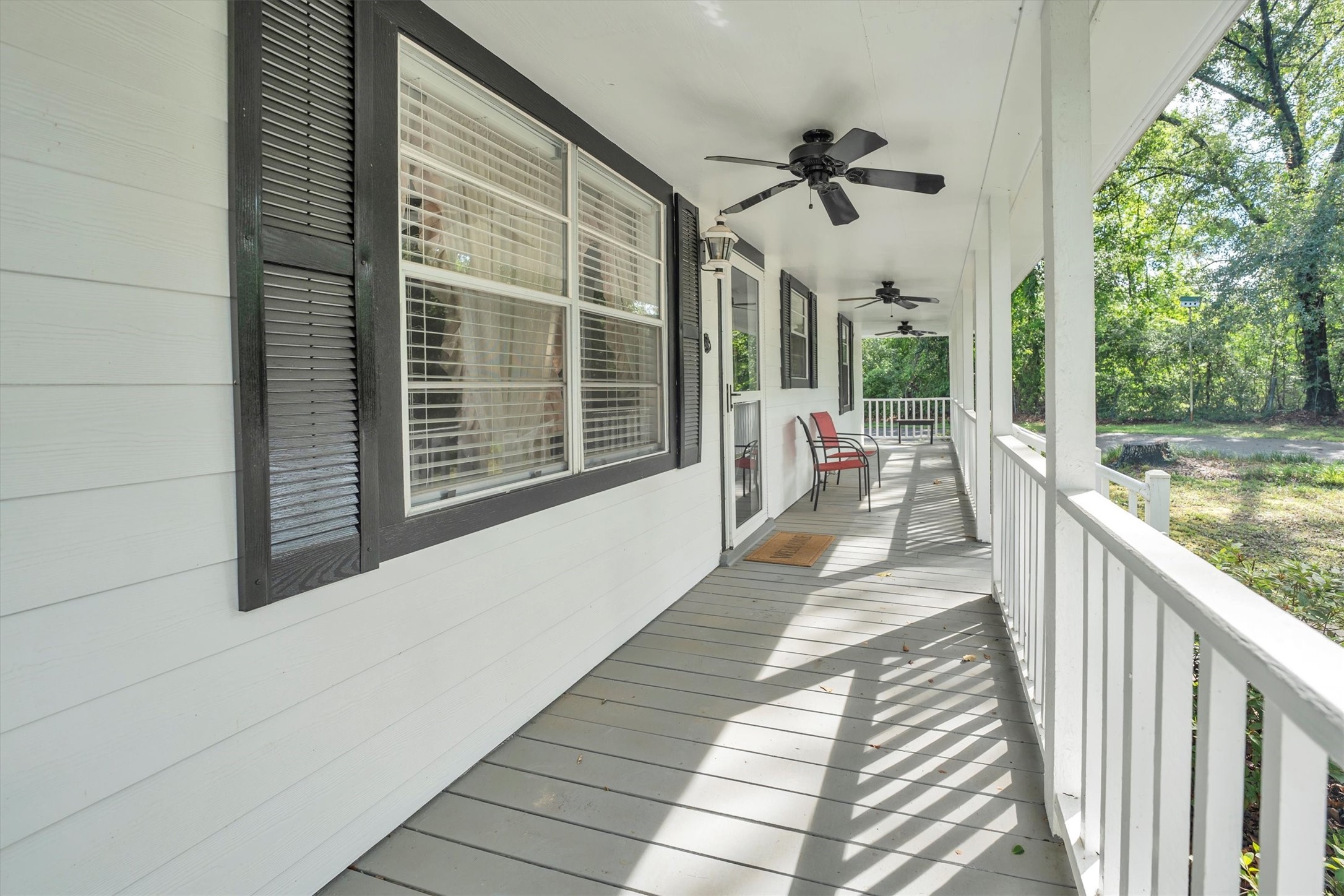 3197 Mann Road Conroe, TX 77303 - Photo 3 of 48 a view of a balcony with floor to ceiling windows with wooden floor