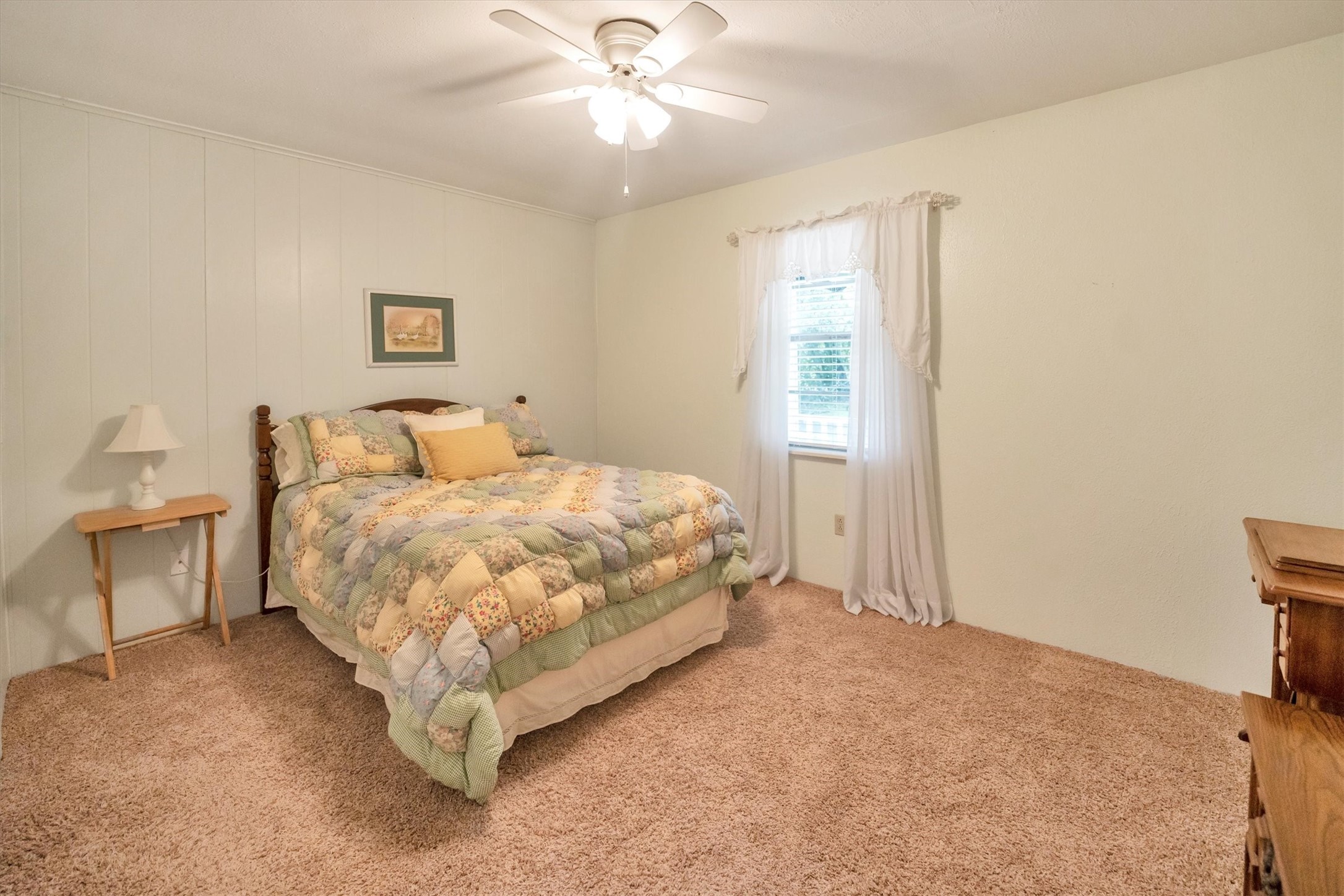 3197 Mann Road Conroe, TX 77303 - Photo 37 of 48 a bedroom with a large bed and a chandelier