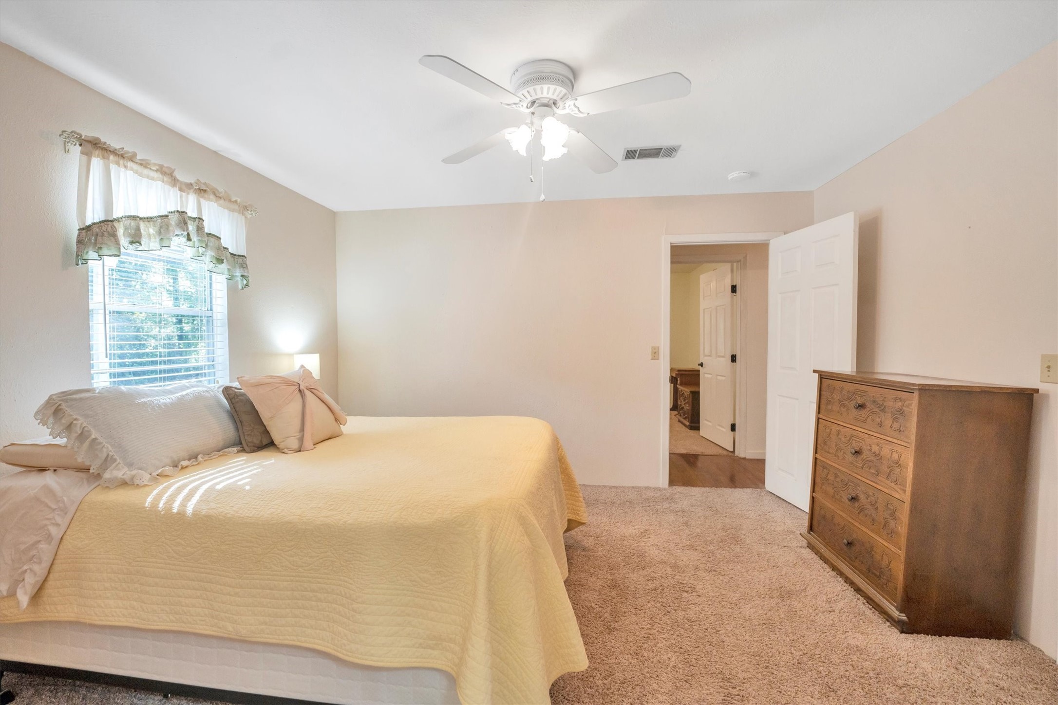 3197 Mann Road Conroe, TX 77303 - Photo 41 of 48 a bedroom with a bed and a chandelier