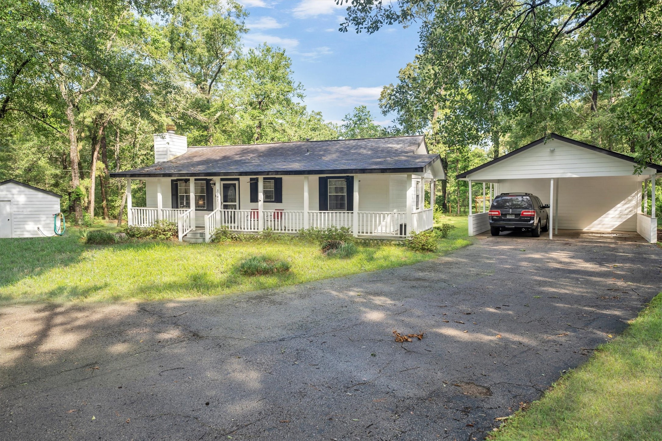 3197 Mann Road Conroe, TX 77303 - Photo 5 of 48 a view of a house with a yard and large tree