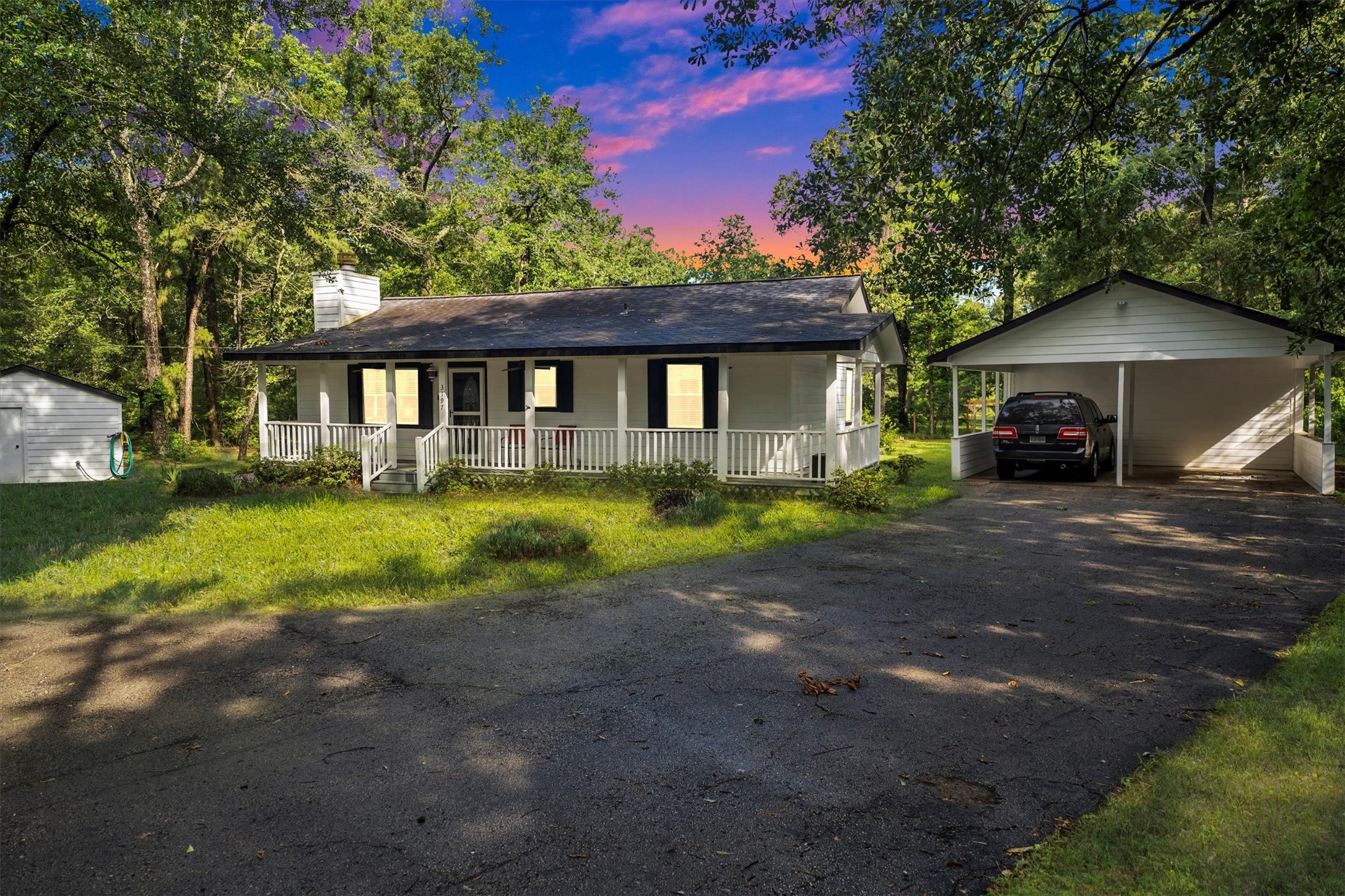 3197 Mann Road Conroe, TX 77303 - Photo 6 of 48 a front view of a house with a yard and garage