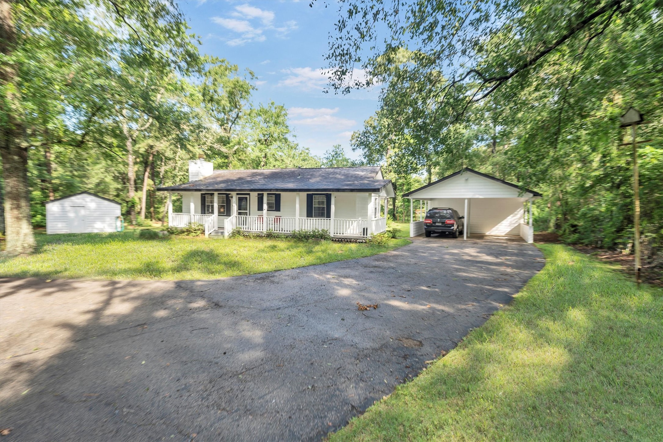 3197 Mann Road Conroe, TX 77303 - Photo 7 of 48 a front view of a house with a yard and garage