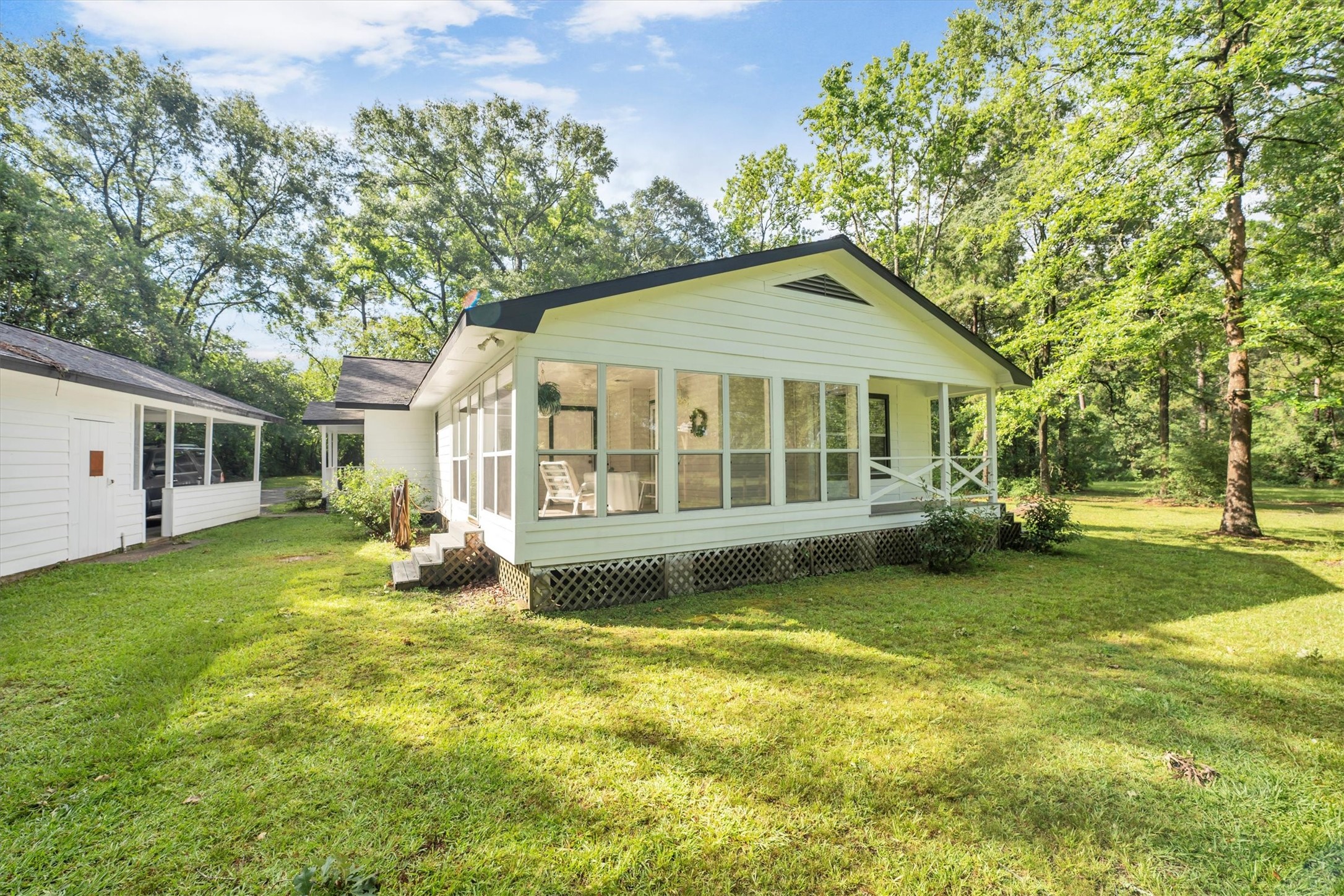 3197 Mann Road Conroe, TX 77303 - Photo 9 of 48 a view of a house with a yard and sitting area