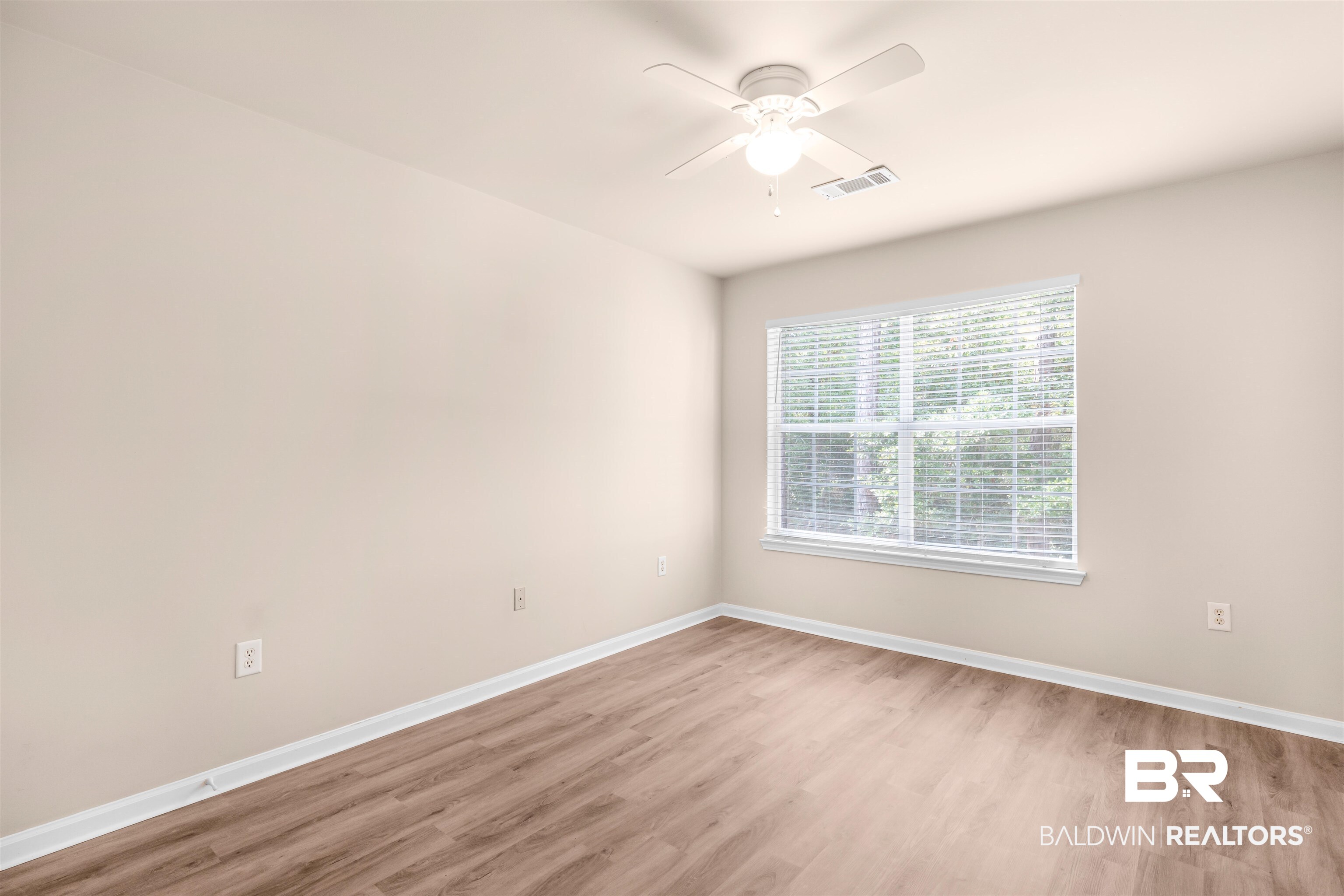 1517 Regency Road, Unit 85 Gulf Shores, AL 36542 - Photo 10 of 32 Unfurnished room with ceiling fan and hardwood / wood-style floors