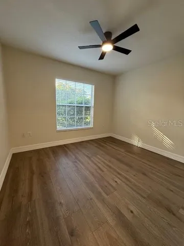 wooden floor in an empty room with a window