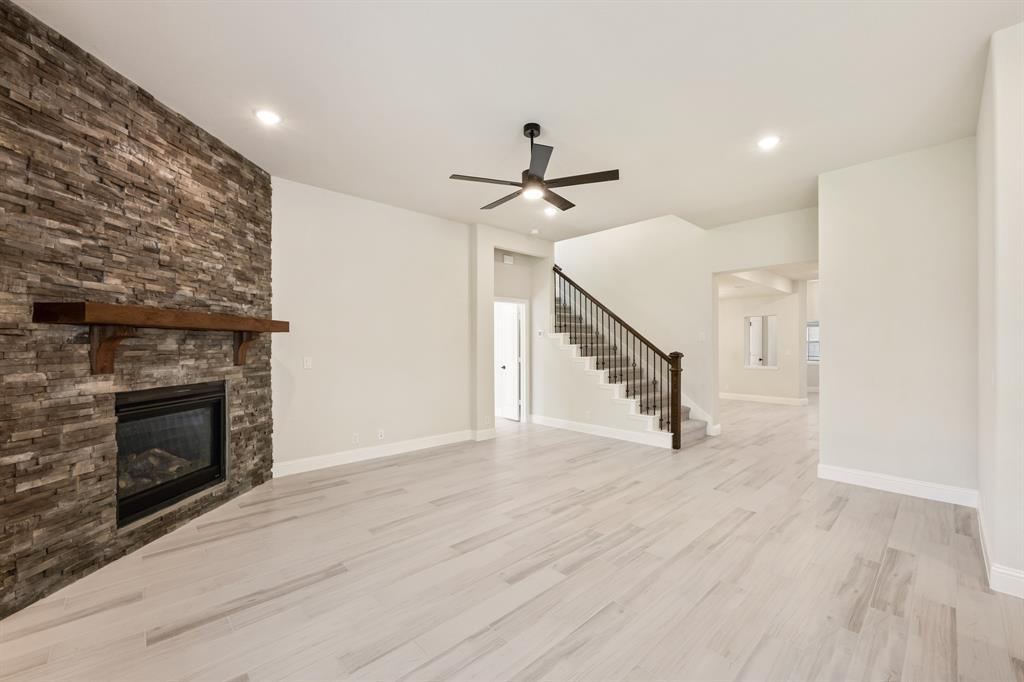 2018 Dundalk Lane Forney, TX 75126 - Photo 16 of 40 a view of an empty room with wooden floor fireplace and a window