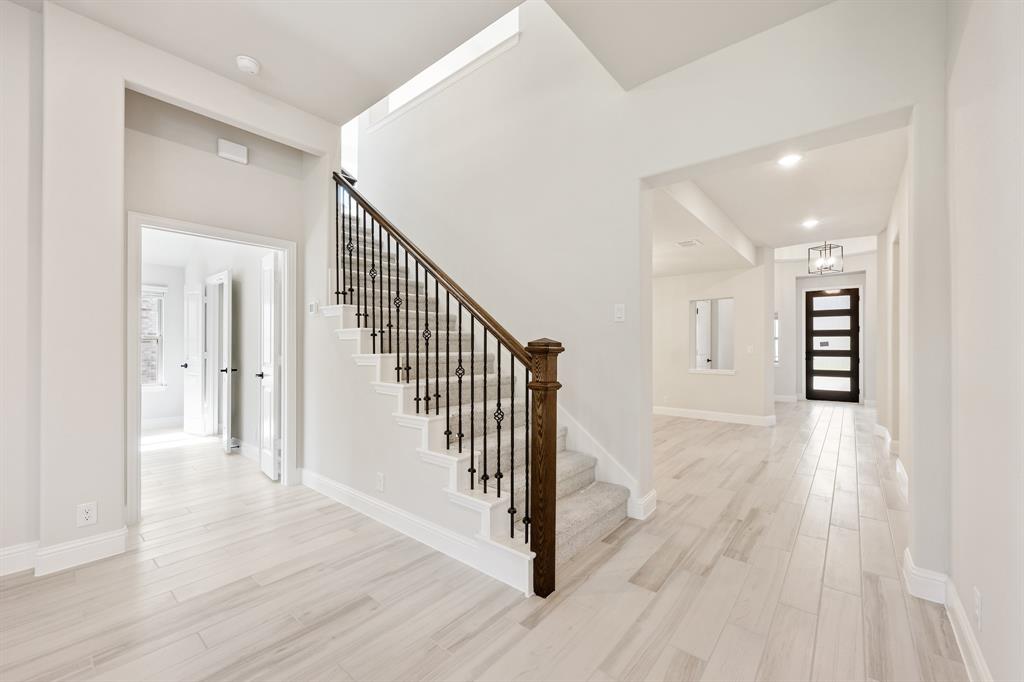 2018 Dundalk Lane Forney, TX 75126 - Photo 28 of 40 a view of a hallway with wooden floor and stairs