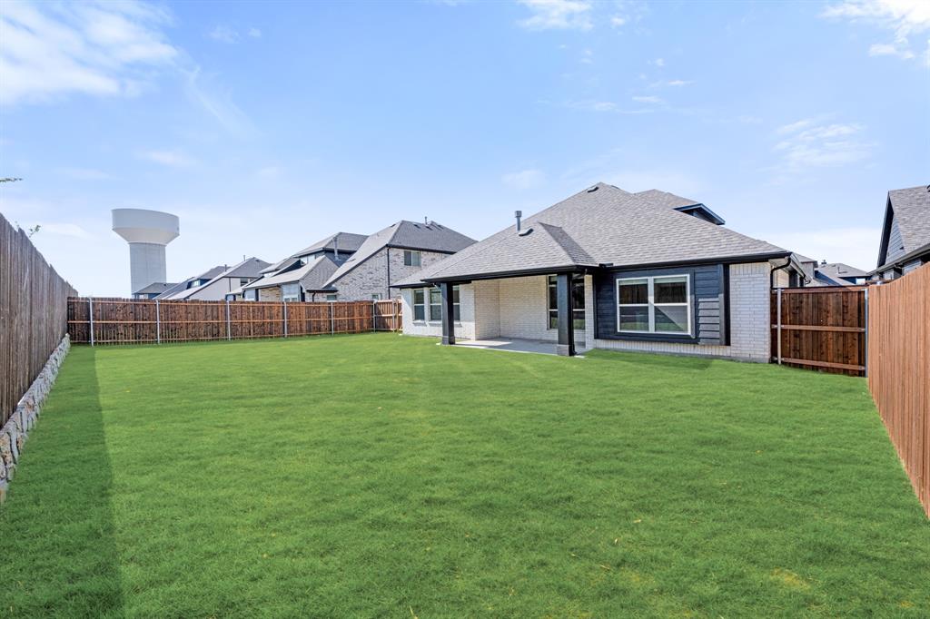 2018 Dundalk Lane Forney, TX 75126 - Photo 38 of 40 a front view of a house with a garden