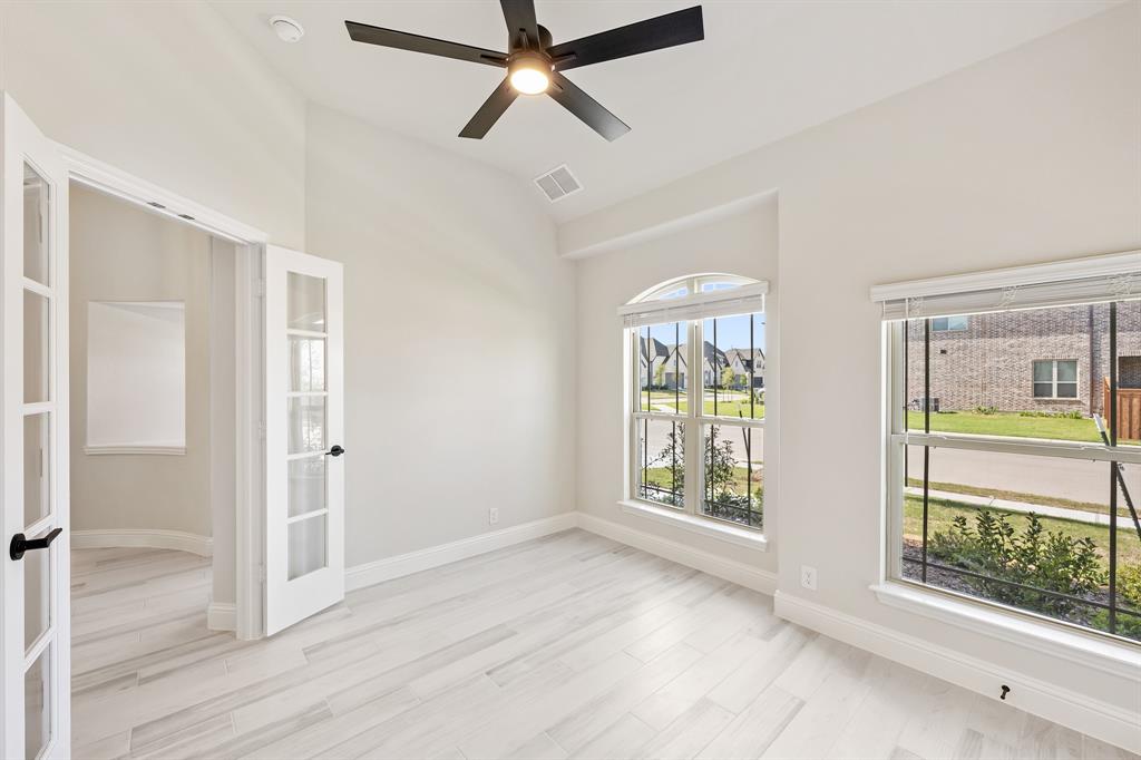 2018 Dundalk Lane Forney, TX 75126 - Photo 7 of 40 a view of an empty room with a window and wooden floor