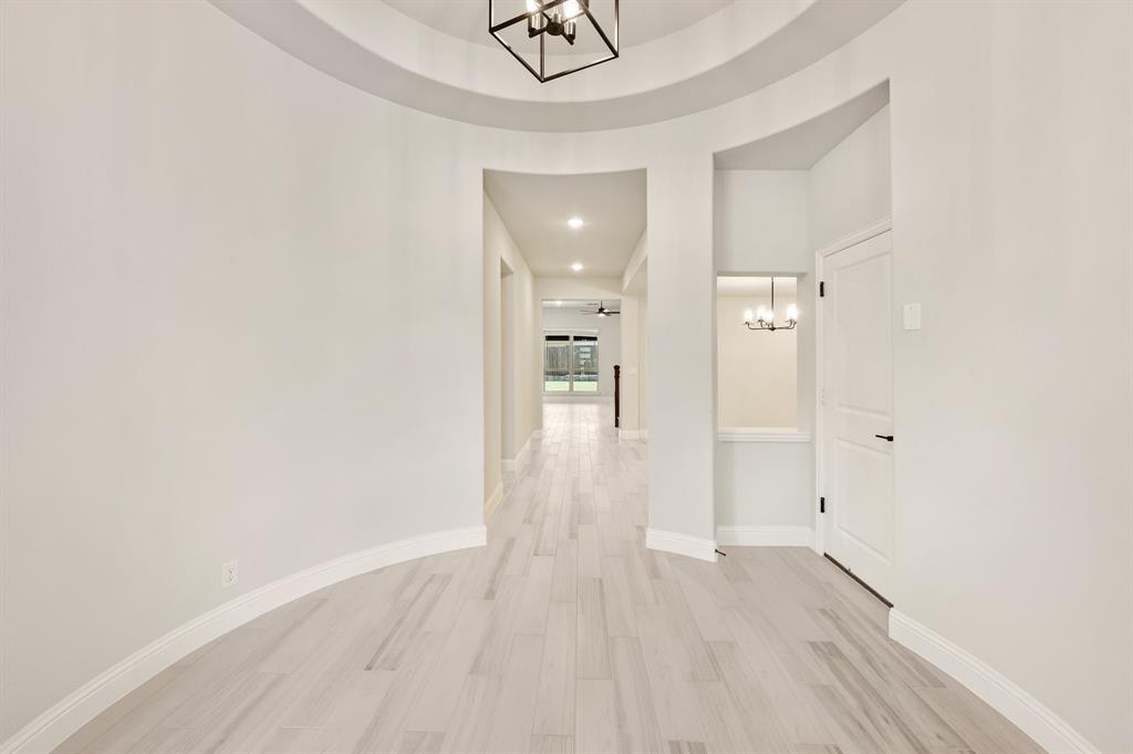 2018 Dundalk Lane Forney, TX 75126 - Photo 8 of 40 a view of a hallway with wooden floor