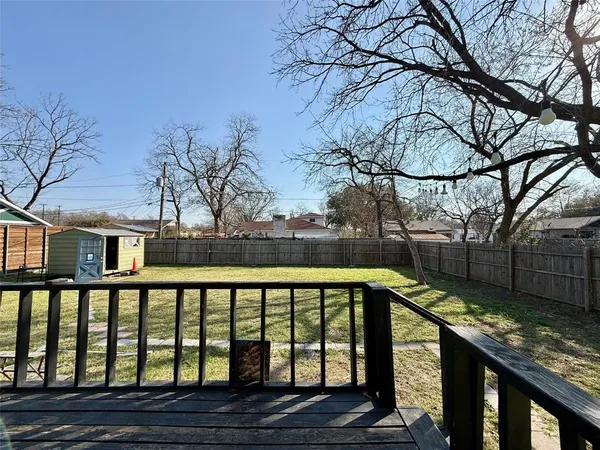 a view of a yard with a house in the background