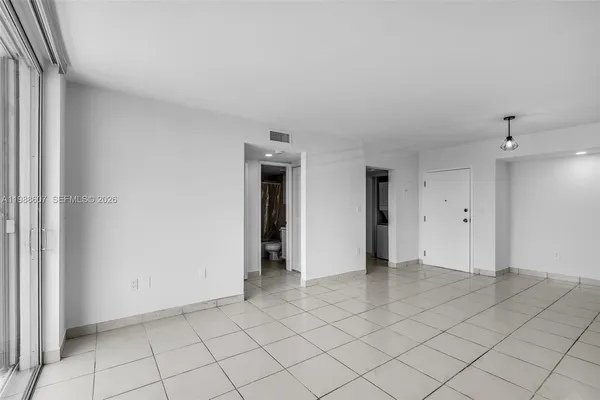 an empty room with white wall and window
