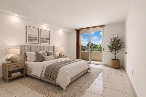 a bedroom with a large bed and a potted plant