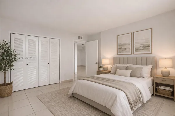 a bedroom with a bed and a potted plant