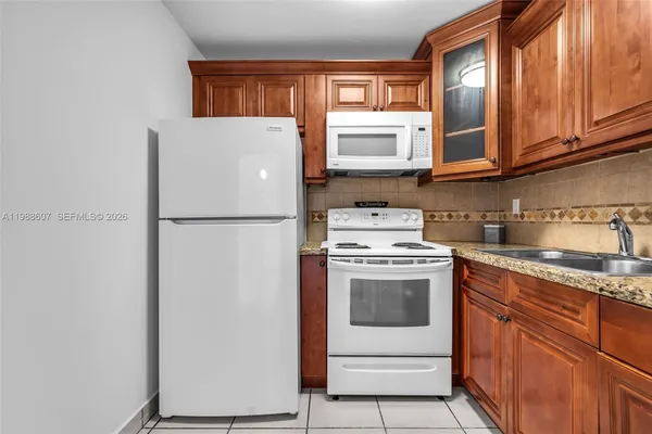 a white refrigerator freezer sitting inside of a kitchen
