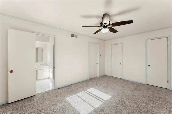 a view of empty room with ceiling fan
