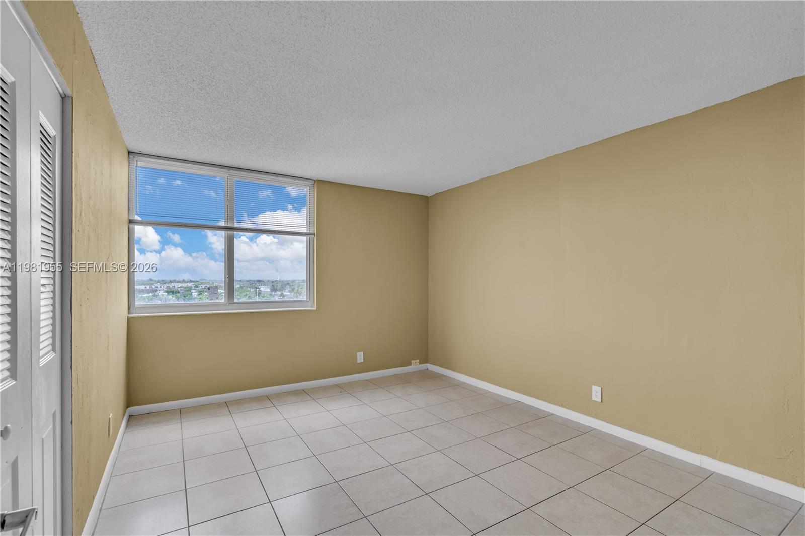 9143 Southwest 77th Avenue, Unit B802 Miami, FL 33156 - Photo 11 of 33 a view of an empty room with a window