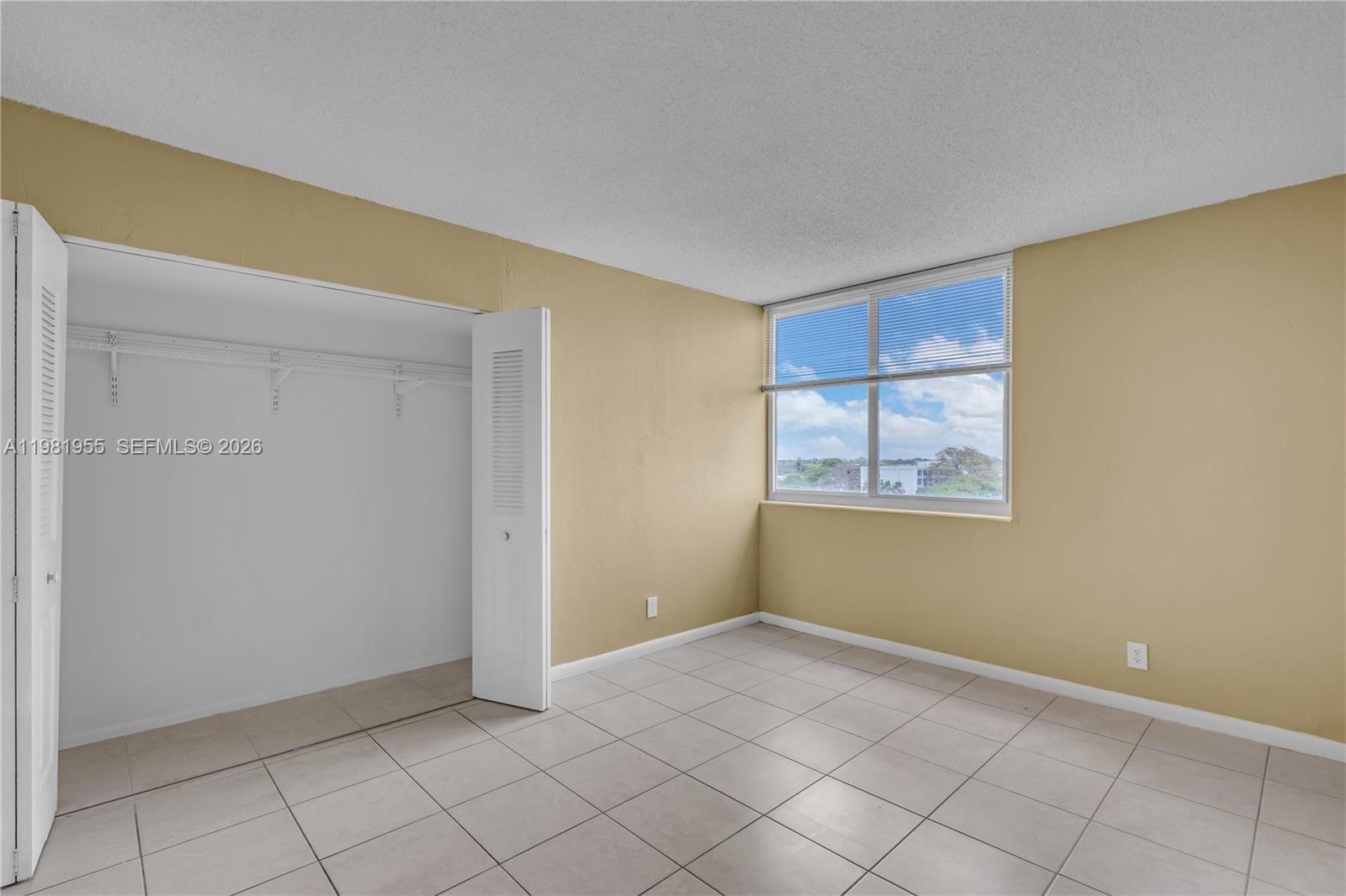 9143 Southwest 77th Avenue, Unit B802 Miami, FL 33156 - Photo 12 of 33 a view of an empty room with window