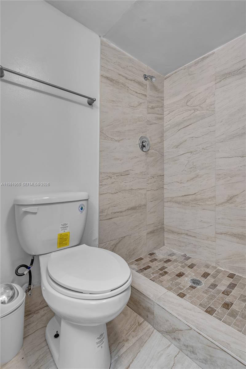 9143 Southwest 77th Avenue, Unit B802 Miami, FL 33156 - Photo 20 of 33 a bathroom with a toilet and a shower