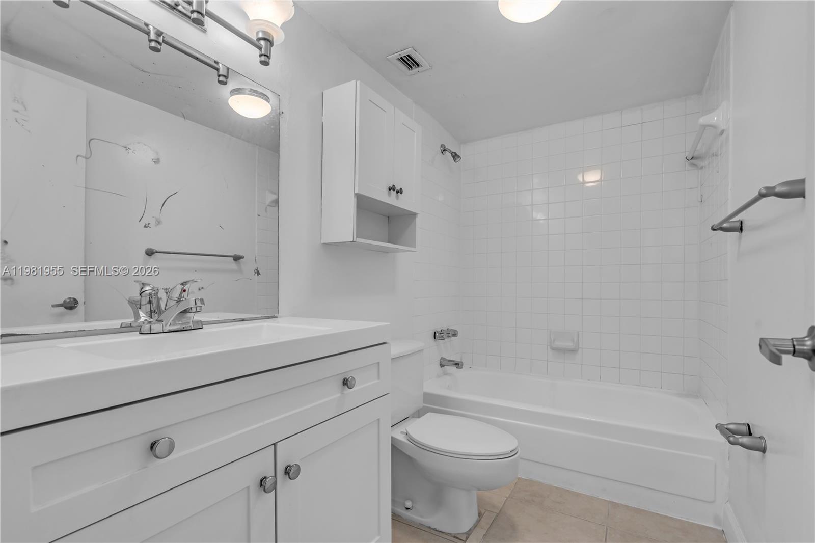 9143 Southwest 77th Avenue, Unit B802 Miami, FL 33156 - Photo 21 of 33 a bathroom with a sink a toilet and shower