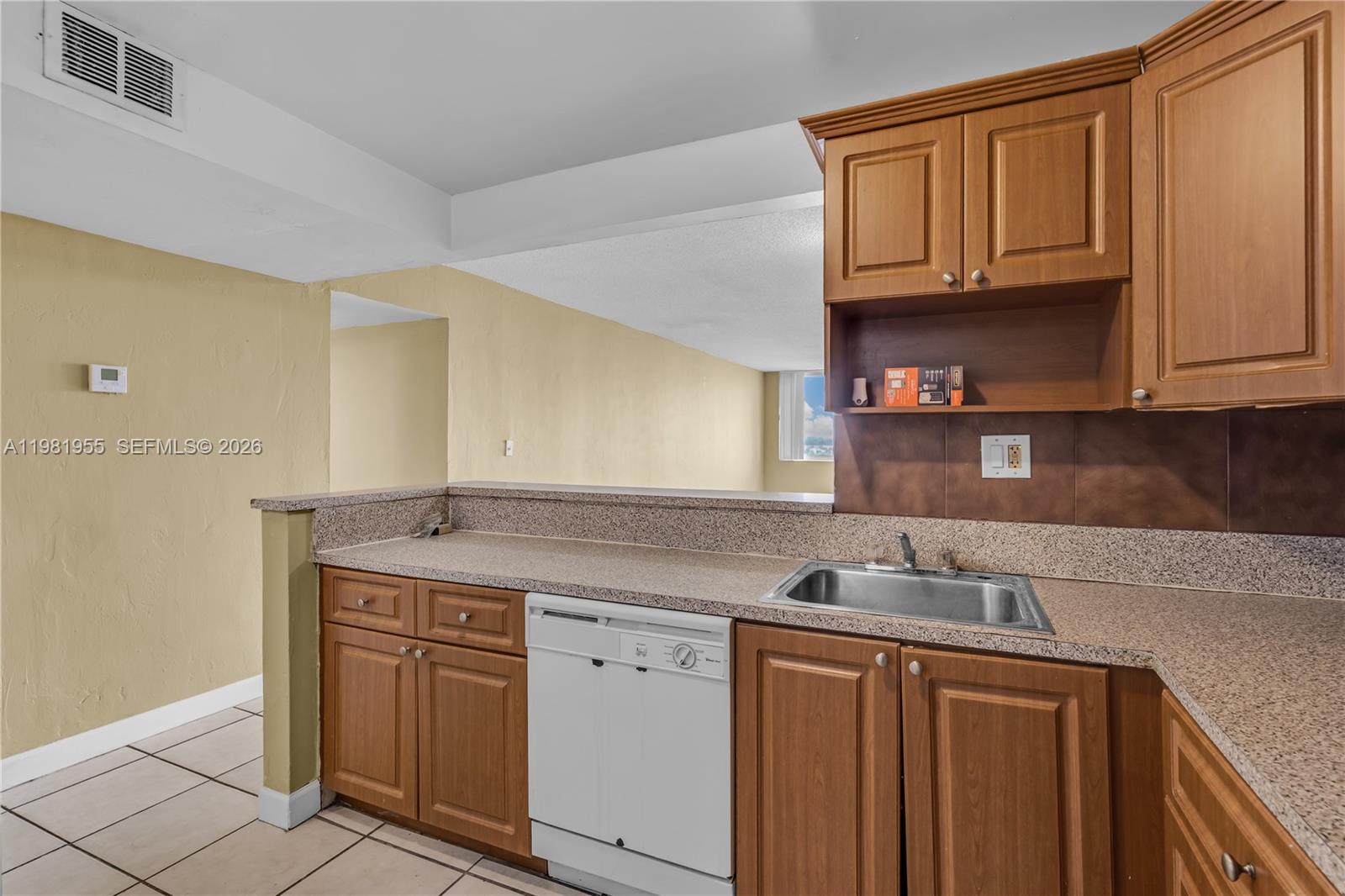 9143 Southwest 77th Avenue, Unit B802 Miami, FL 33156 - Photo 6 of 33 a kitchen with stainless steel appliances granite countertop a sink and cabinets