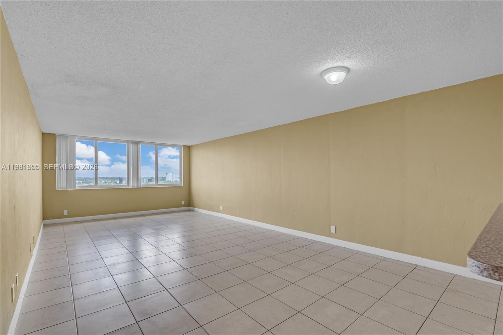 9143 Southwest 77th Avenue, Unit B802 Miami, FL 33156 - Photo 8 of 33 a view of an empty room with a window
