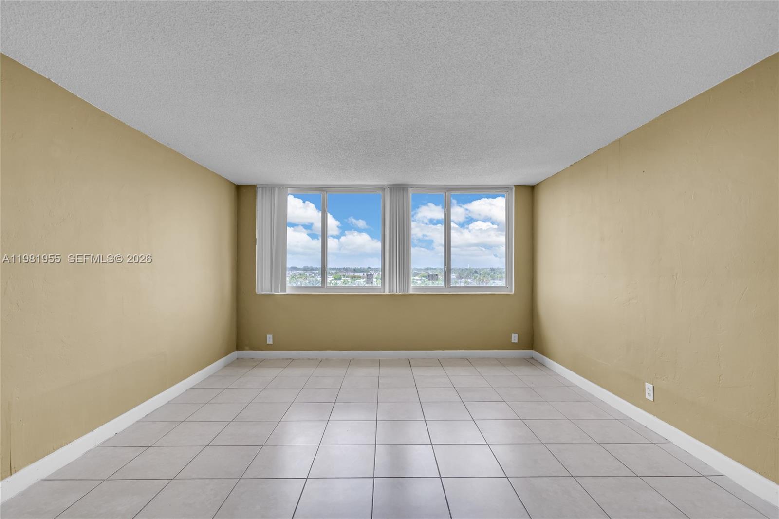 9143 Southwest 77th Avenue, Unit B802 Miami, FL 33156 - Photo 9 of 33 a view of an empty room with a window