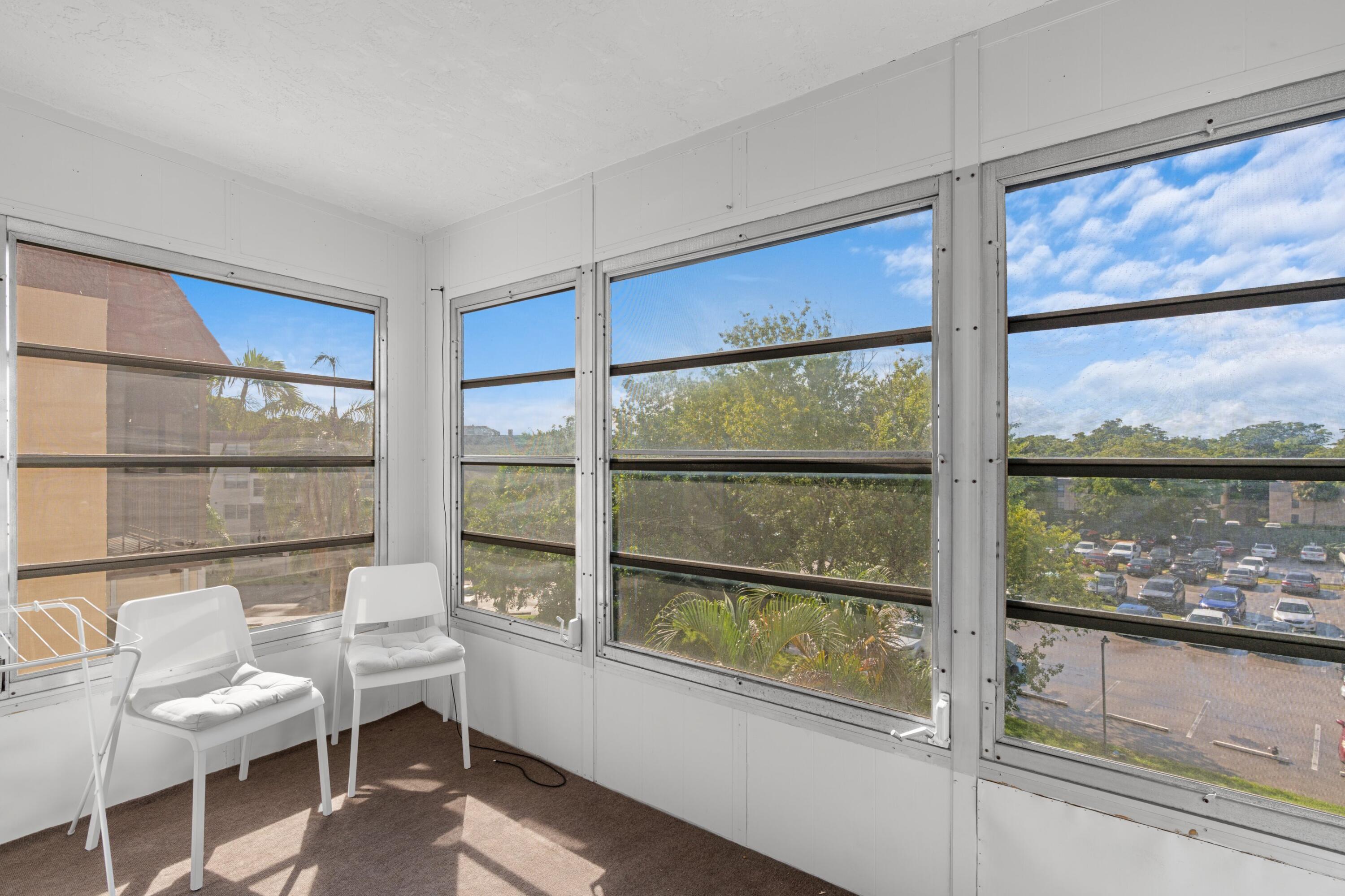 7000 Northwest 17th Street, Unit 419 Plantation, FL 33313 - Photo 11 of 23 a room with a large window and a bed
