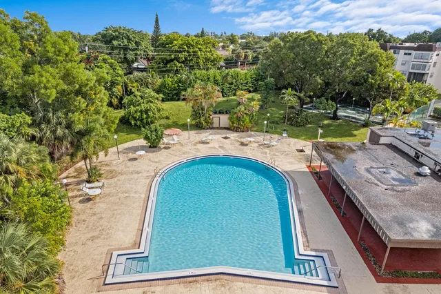 a front view of a residential apartment building with a yard