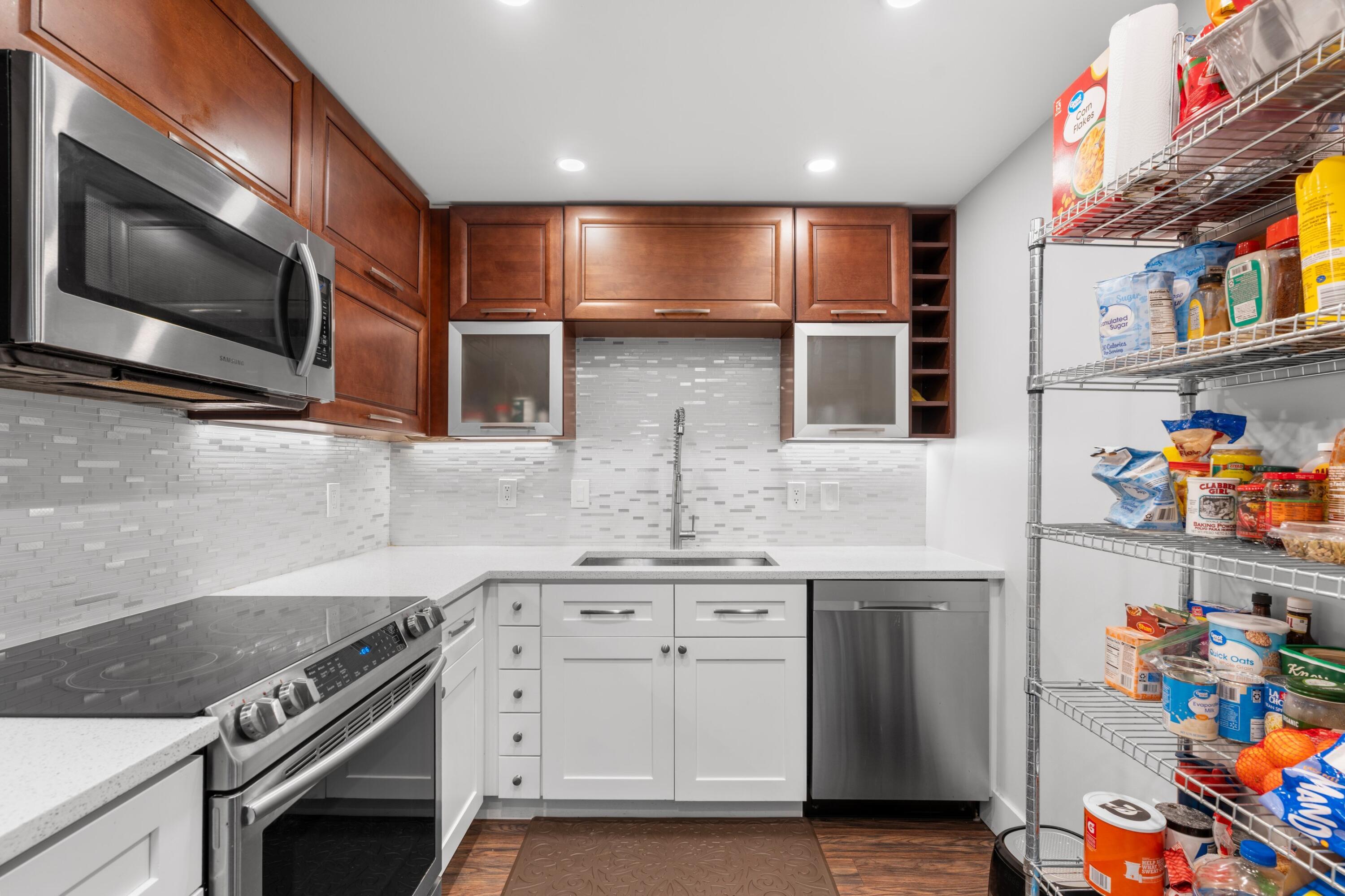 7000 Northwest 17th Street, Unit 419 Plantation, FL 33313 - Photo 5 of 23 a kitchen with stainless steel appliances granite countertop a stove and a microwave