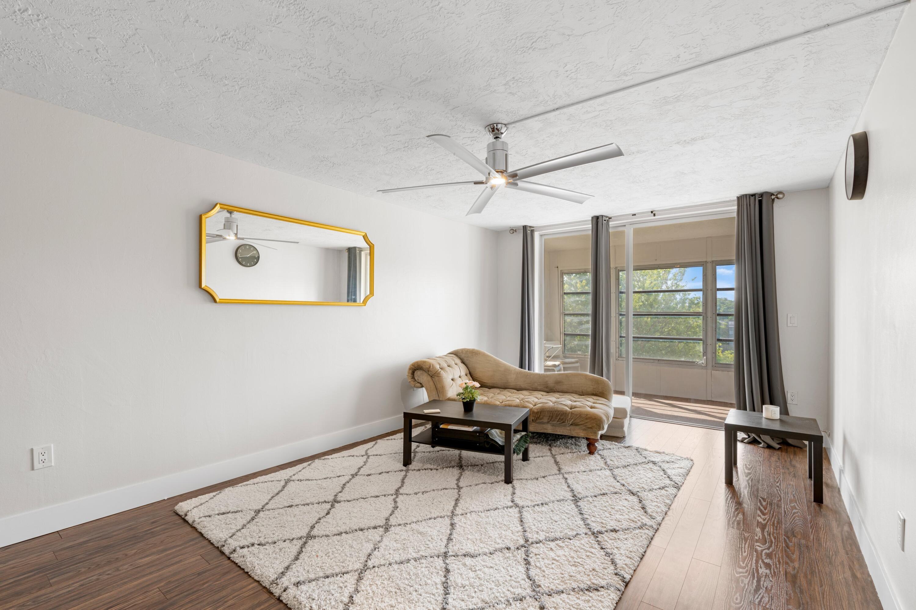 7000 Northwest 17th Street, Unit 419 Plantation, FL 33313 - Photo 8 of 23 a living room with a couch and a table