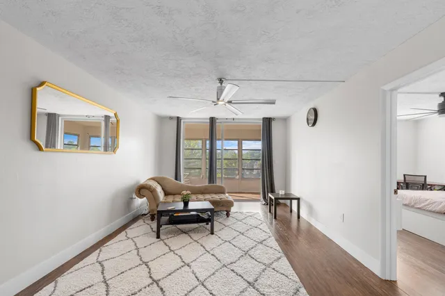 a living room with furniture and a floor to ceiling window