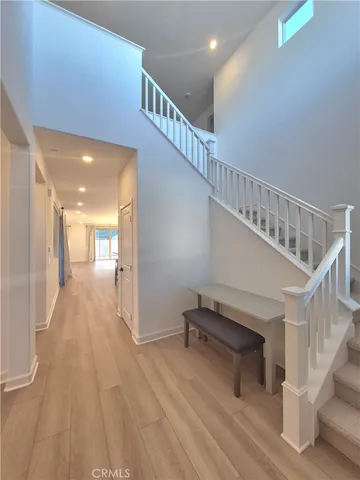 a view of entryway and hall with wooden floor